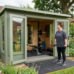 Outdoor garden gym with equipment, person practising strength training using dumbbells near a shed gym setup
